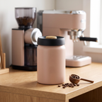 Matte stainless steel vacuum-seal coffee canister with beans at a home coffee station