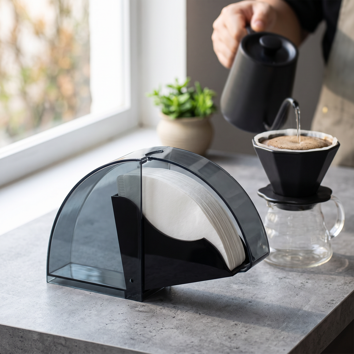Acrylic dustproof V60 coffee filter dispenser beside a pour-over dripper and kettle