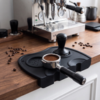 Silicone espresso tamping mat with portafilter and tamper on a walnut espresso bar