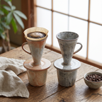 Rustic ceramic pour over dripper with side handle brewing on a wooden table