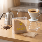 Cone paper coffee filters for V60-style drippers on a light oak coffee bar beside a pour-over setup