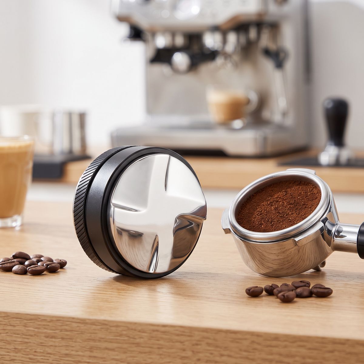 53mm 2-in-1 coffee distributor and tamper beside a portafilter on a light oak espresso bar